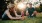 a woman and a man sitting on grass